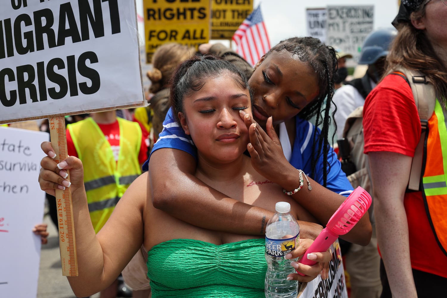 (L-R) Daisy Moran and Constance Felton are seen as police block their marching route during a protest on ICE raids and deportation arrests on Chamblee Tucker Road in Atlanta on Saturday, June 14, 2025. (Arvin Temkar / AJC)