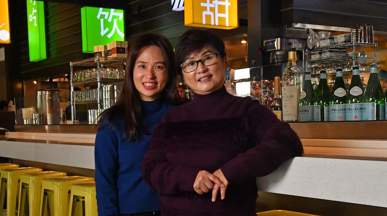 Rachel Ewe and her mother Amy Wong in the bar and open kitchen area of Food Terminal in Chamblee. Rachel's sister Jane Ewe and their mother Amy Wong joined us on this week's Go Atlanta podcast. (CHRIS HUNT FOR THE ATLANTA JOURNAL-CONSTITUTION)