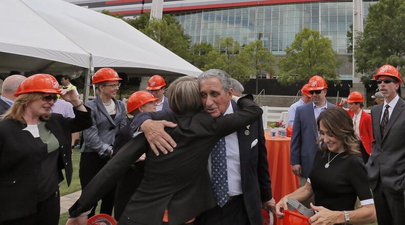 April 21, 2017 - Atlanta - Arthur Blank (center) joins a group from Home Depot for a photo at the announcement of the new greenspace. The opening of the new Mercedes-Benz Stadium may have been moved back again, but the Atlanta Falcons are looking ahead at greenspace that will be created by the demolition of the Georgia Dome. The team unveiled plans for the “Home Depot Backyard” Friday. Arthur Blank was in attendance along with Mayor Kasim Reed, Home Depot CEO Craig Menear, GWCCA Chairman David Allman and Frank Fernandez, VP of Community Development for The Arthur M. Blank Family Foundation. BOB ANDRES /BANDRES@AJC.COM