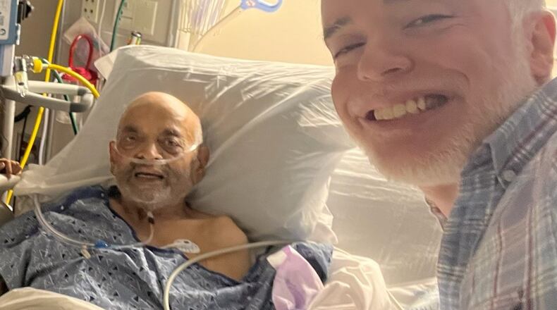 Dhaval Desai at the bedside of his father, Rohit N. Desai, during his father’s final days last year. (photo courtesy of the Desai family.)