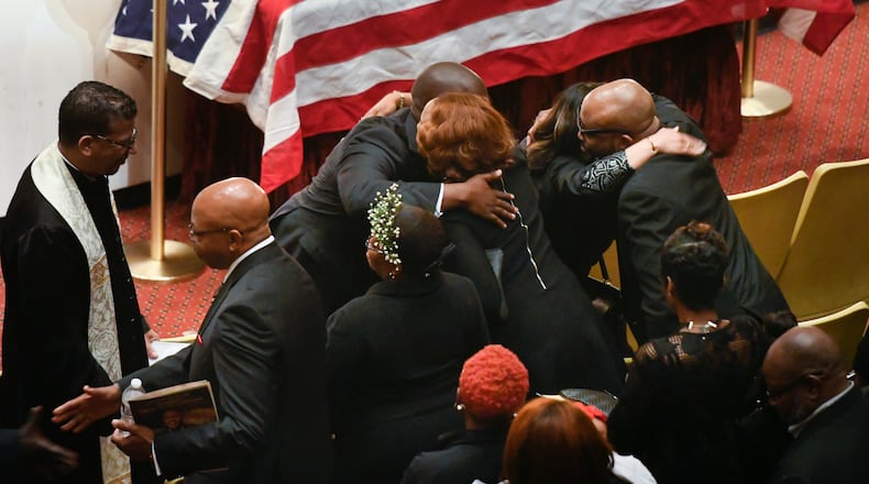 Family members are hugged by clergy during a memorial service for CDC researcher Timothy Cunningham, who was pulled from the Chattahoochee River after being missing for seven weeks, held Saturday at Morehouse April 21, 2018.