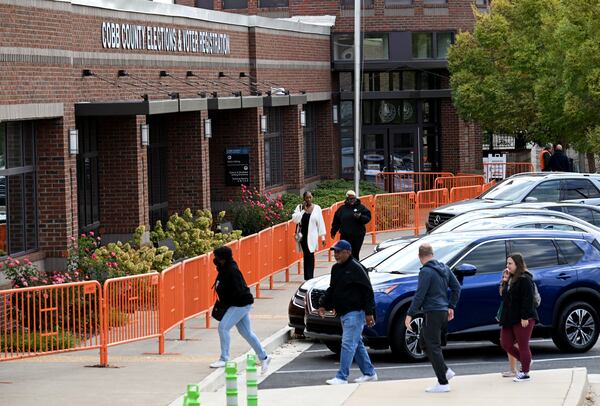 Voters arrive at an early voting location in Cobb County on Oct. 15, the first day of this year's early voting period. (Hyosub Shin / AJC)