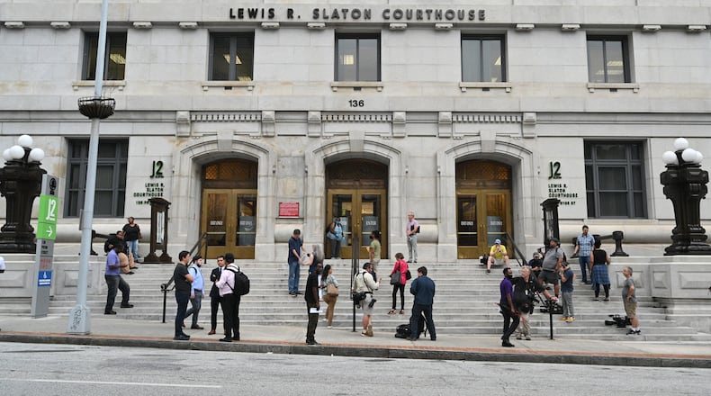 Members of media wait outside the Fulton County Courthouse for the arrival of Rudy Giuliani on Wednesday, August 17, 2022. Rudy Giuliani, the onetime personal attorney of former President Donald Trump, entered the Fulton County courthouse on Wednesday morning to testify before the special purpose grand jury examining Georgia’s 2020 elections. (Hyosub Shin / Hyosub.Shin@ajc.com)