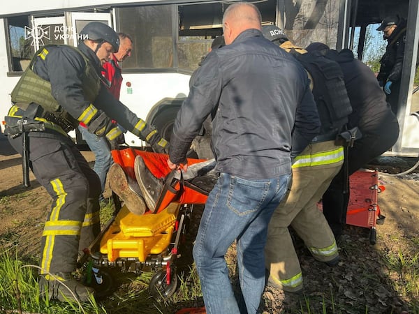 In this photo provided by the Ukrainian Emergency Service, rescuers carry out bodies of passengers after a Russian drone hit a public bus in Marhanets, Dnipropetrovsk region, Wednesday, April 23, 2025. (Ukrainian Emergency Service via AP)