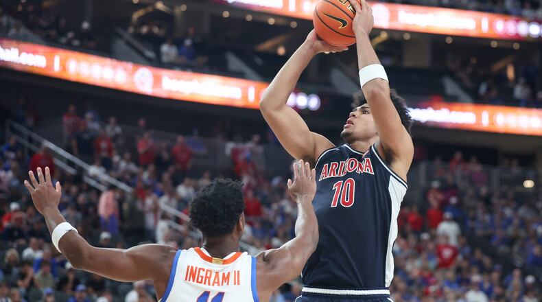 Arizona forward Koa Peat (10) shoots against Florida guard CJ Ingram (11) during the second half of an NCAA college basketball game, Monday, Nov. 3, 2025, in Las Vegas. (AP Photo/Ian Maule)