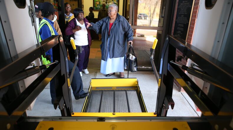 Sarah Colquitt points to one of the Transdev bus drivers to make sure she will watch her in case she slips on the way up the lift to the bus at the Southeast Neighborhood Senior Center in Atlanta. (HENRY TAYLOR / HENRY.TAYLOR@AJC.COM) AJC FILE PHOTO