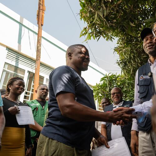 Director General of the World Health Organisation (WHO), Tedros Adhanom Ghebreyesus, right, shakes hands with Ezo Etienne, a health worker who recovered from Ebola in Bunia, Congo, Sunday, May 31, 2026. (AP Photo/Moses Sawasawa)