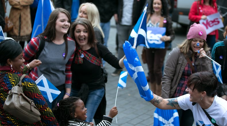 EDINBURGH, SCOTLAND - SEPTEMBER 14: Yes supporters celebrate outside the Usher Hall, which is hosting a Night for Scotland on September 14, 2014 in Edinburgh, Scotland. With the campaigning for the independence referendum entering into the final few days, the latest opinion polls have suggested the outcome of the vote is still too close to call. (Photo by Matt Cardy/Getty Images)