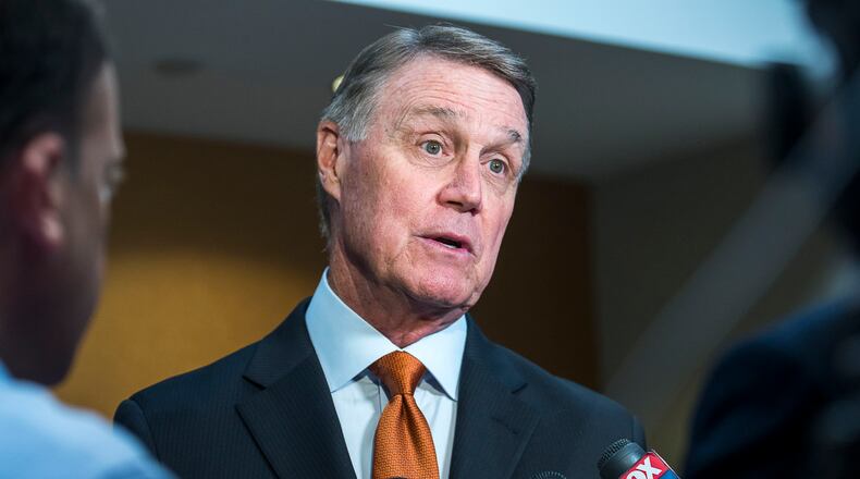U.S. Sen. David Perdue (R-GA) speaks with media following a talk at the Kiwanis Atlanta Club luncheon meeting at the Loudermilk Conference Center in downtown Atlanta, Tuesday, August 6, 2019.  (Alyssa Pointer/alyssa.pointer@ajc.com)