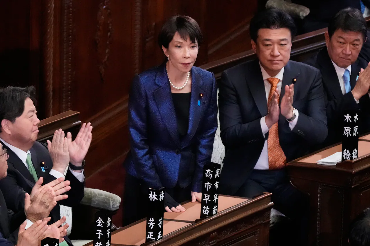 Members of the lower house of Japan's Parliament applaud after Prime Minister Sanae Takaichi (center) was reelected during a special session in February. (Eugene Hoshiko/AP)