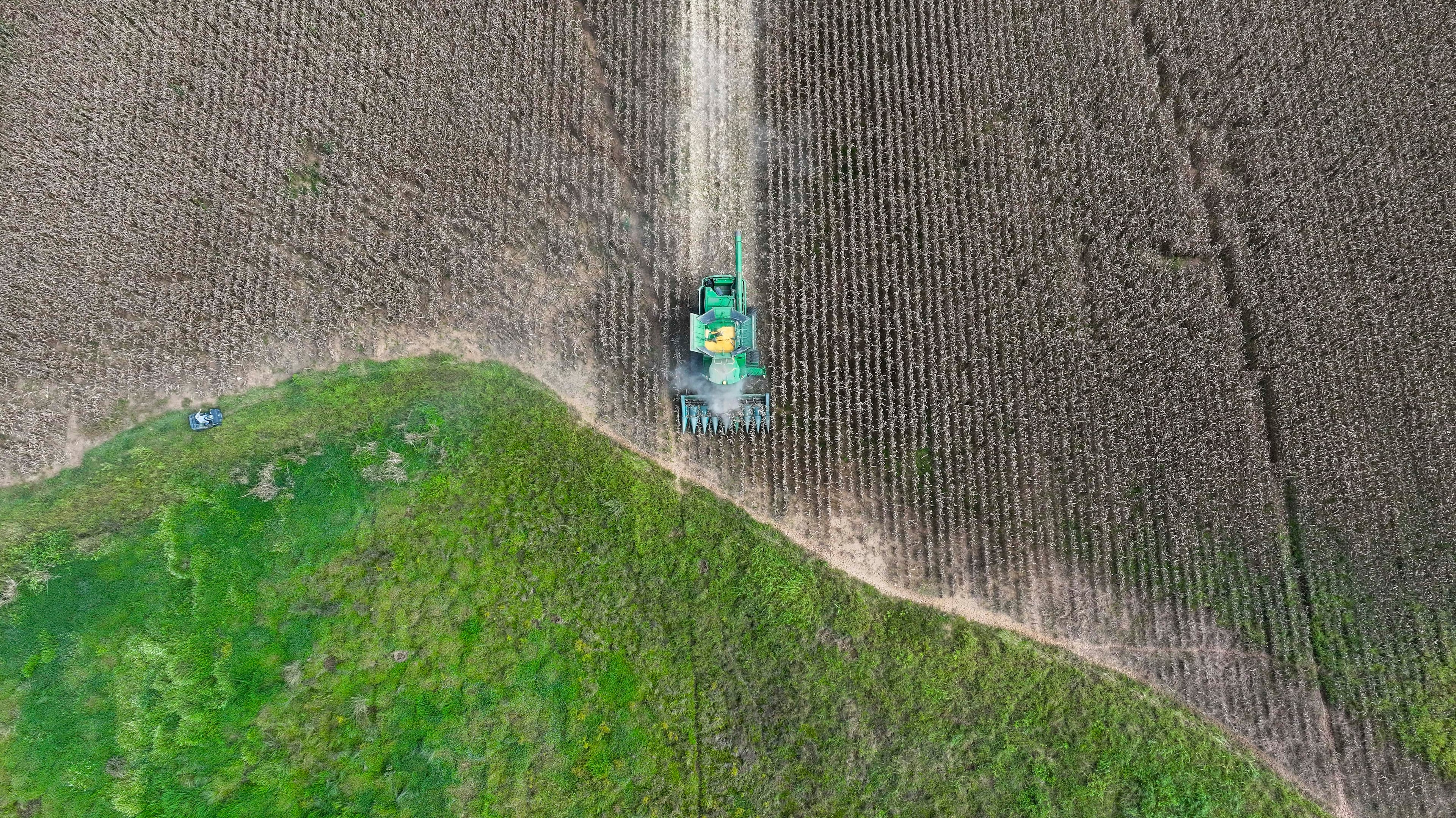 An aerial image shows a tractor harvesting corn at Iron Horse Farm with the J. Phil Campbell Sr. Research and Education Center during a demonstration of precise harvesting with the latest technology from Georgia-based AGCO Corp., on Monday, September 8, 2025. (Miguel Martinez/ AJC)