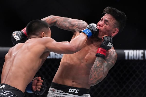 Joshua Van hits Brandon Royval in a flyweight fight at UFC 317, Saturday, June 28, 2025, in Las Vegas. (AP Photo/John Locher)