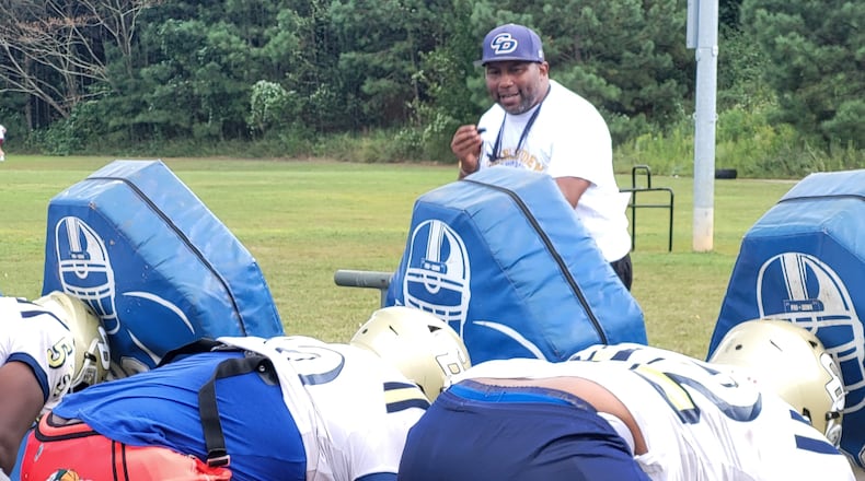 Drew coach Steve Robinson works with the offensive line at practice on Sept. 18, 2024, at Drew High School.