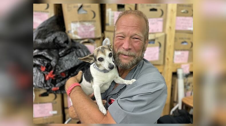 Don Bickford and his adopted dog, Maggie, pose at the East Ridge Church of Christ Benevolent Center in Chattanooga. (Photo Courtesy of Mark Kennedy)