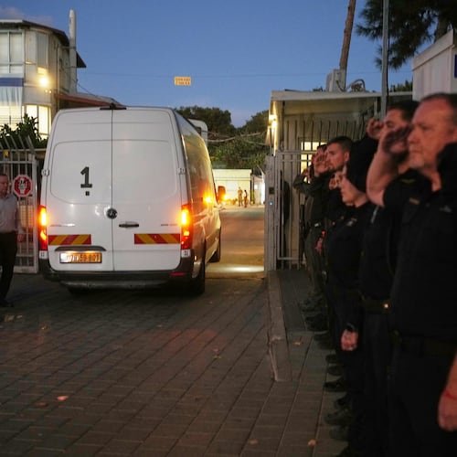 A vehicle carrying the remains of a person whom Hamas claims is a deceased hostage, transferred earlier today by Gaza militants to Israeli authorities, arrives at the Abu Kabir Forensic Institute in Tel Aviv, Israel, Tuesday, Dec. 2, 2025. (AP Photo/Ohad Zwigenberg)
