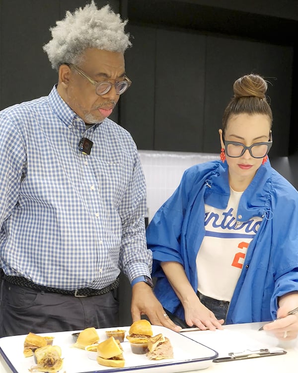 UATL Senior Editor Ernie Suggs (left) and Food & DIning Senior Editor Monti Carlo (right) prepare for the AJC's Best Pulled Pork Sandwich in Atlanta taste test.