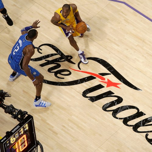 FILE - Los Angeles Lakers guard Kobe Bryant dribbles as Orlando Magic center Dwight Howard defends during the second half of Game 1 of the NBA basketball finals June 4, 2009, in Los Angeles. (AP Photo/Mark J. Terrill, File)