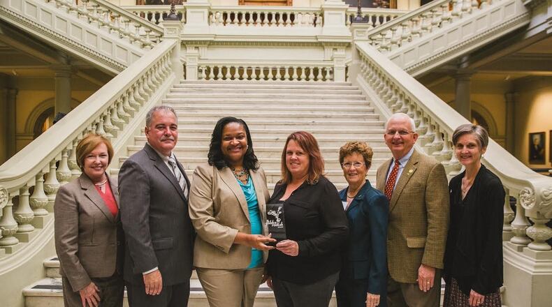 From left, Public Health Commissioner Dr. Brenda Fitzgerald, State School Superintendent Richard Woods, Fayette County School Nutrition Director Kokeeta Wilder, Fayette County School Nutrition Lead Manager Ginger McCann, Fayette County Master Gardener Sandy Golden, Commissioner of Agriculture Gary Black, and Georgia Organics Executive Director Alice Rolls at the Georgia State Capitol for the 2016 Golden Radish Award ceremony.