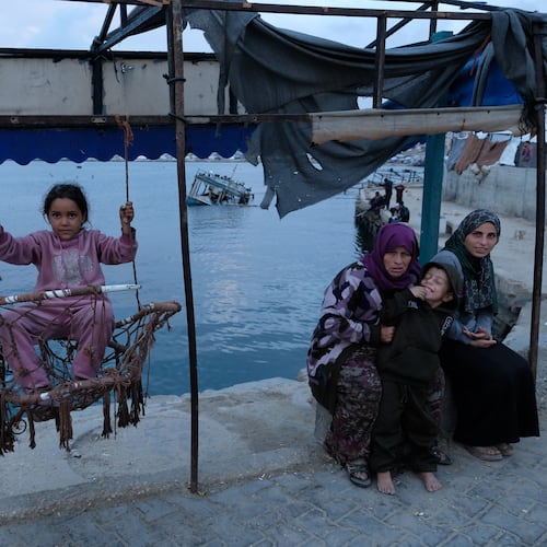 A Palestinian girl sits on a swing in the port of Gaza City on the Mediterranean Sea, Saturday, Dec. 6, 2025. (AP Photo/Jehad Alshrafi)