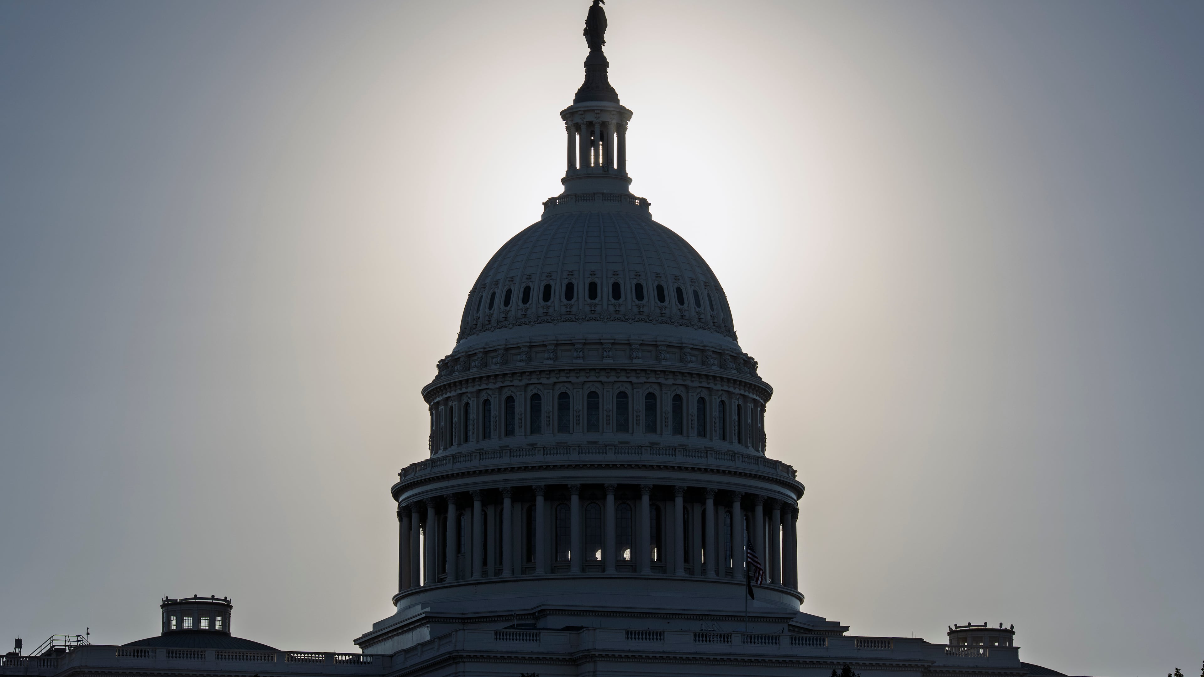 The Capitol is silhouetted by the stark glare of the morning sun as a government shutdown begins its tenth day, in Washington, Friday, Oct. 10, 2025. (AP Photo/J. Scott Applewhite)