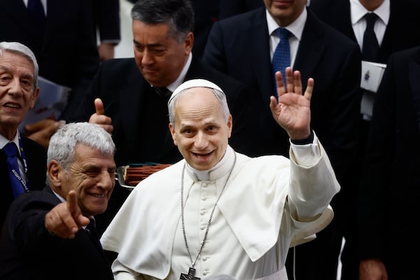 Pope Leo XIV waves to photographers during an audience in the Paul VI Hall at the Vatican on Monday, May 12, 2025, with members of the international media who covered the recent conclave in which he was elected. (Cecilia Fabiano/LaPresse via AP)