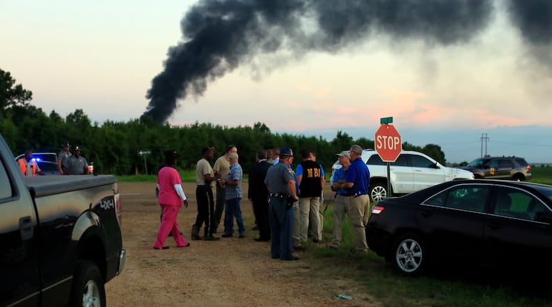 Emergency officials respond to the site of a military plane crash near Itta Bena, Miss., Monday, July 10, 2017. Leflore County Emergency Management Agency Director Frank Randle told reporters at a late briefing that more than a dozen bodies had been recovered after the KC-130 spiraled into the ground about 85 miles (135 kilometers) north of Jackson in the Mississippi Delta. (Elijah Baylis/The Clarion-Ledger via AP)