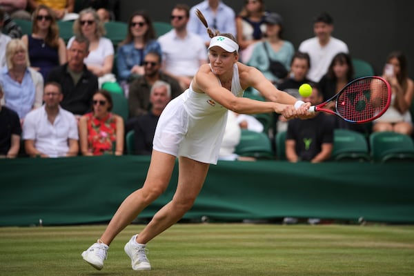 Elena Rybakina of Kazakhstan plays a return to Clara Tauson of Denmark during their women's singles third round match at the Wimbledon Tennis Championships in London, Saturday, July 5, 2025.(AP Photo/Kin Cheung)