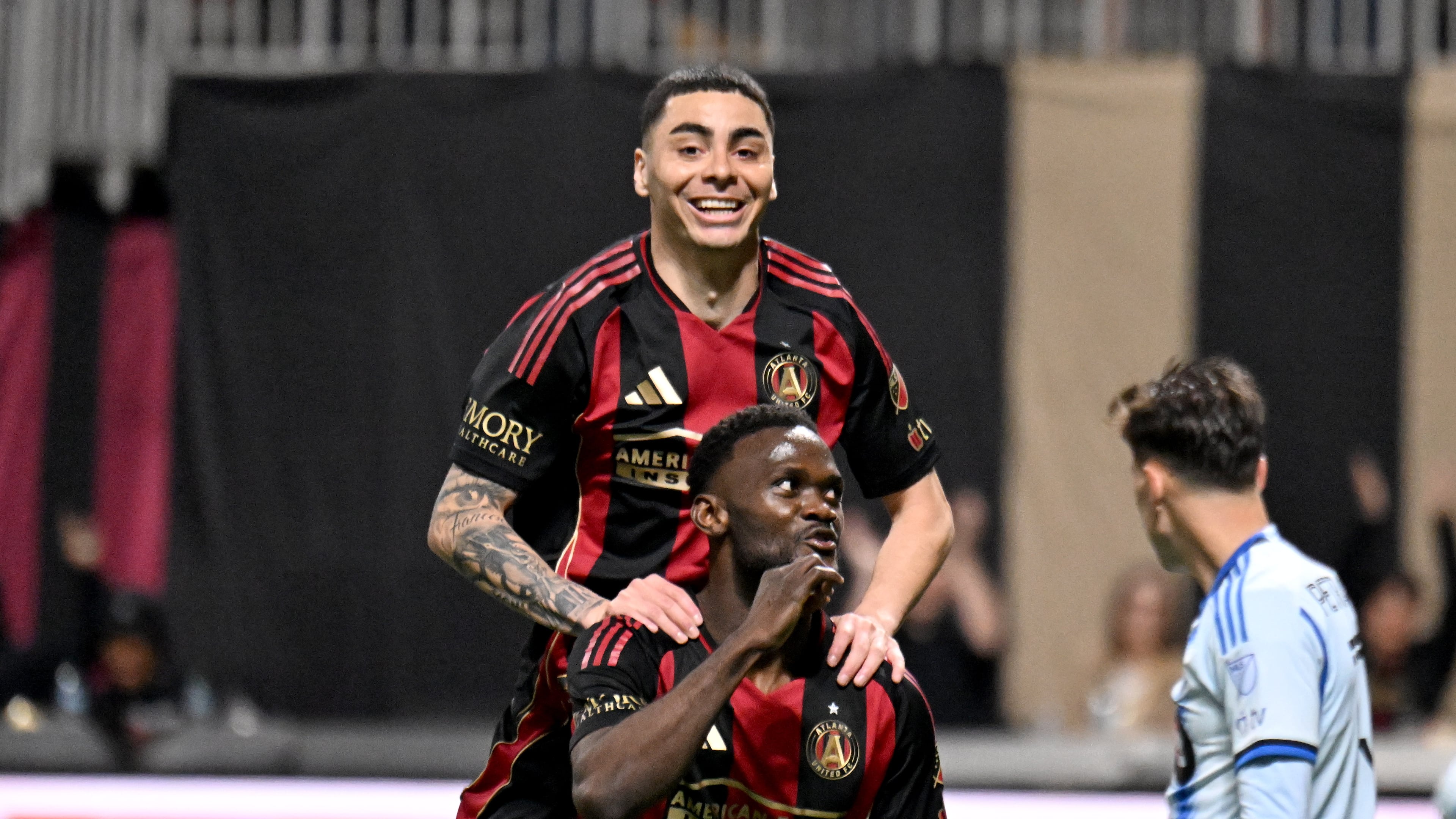 Atlanta United midfielder Miguel Almirón (behind) celebrates Atlanta United forward Emmanuel Latte Lath after Latte Lath scored during the second half of Atlanta United’s MLS season opener at Mercedes-Benz Stadium, Feb. 22, 2025, in Atlanta. Atlanta United won 3-2 over CF Montreal. (Hyosub Shin/AJC)