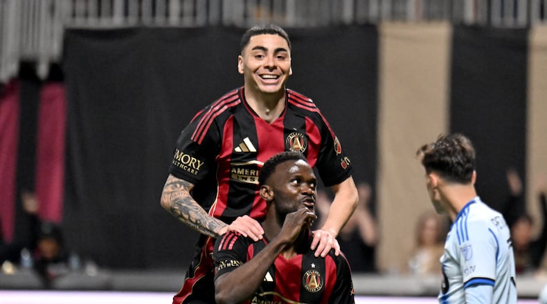 Atlanta United forward Emmanuel Latte Lath is celebrated by midfielder Miguel Almiron (behind) after scoring during United’s season opener at Mercedes-Benz Stadium on Saturday, Feb. 22, 2025. Atlanta United is off to a miserable start, including a 3-0 loss to Orlando last week. (Hyosub Shin/AJC)