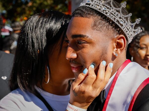 Kim Hayes kisses her son Malachai Hayes, who is “Mr. Sophomore,” during the Clark Atlanta University homecoming parade in Atlanta on Saturday, Oct. 15, 2022. (Arvin Temkar/AJC)