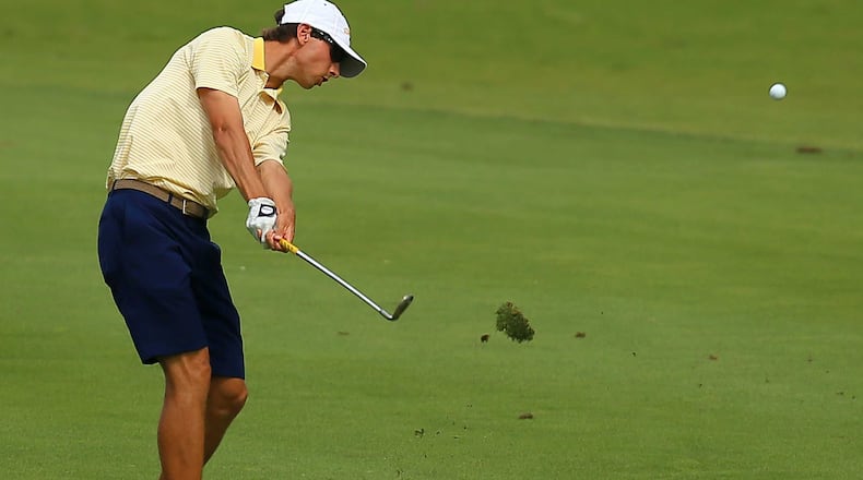 Seth Reeves of Georgia Tech takes a big divot hitting his fairway shot to the 14th green during the third round of the NCAA golf championships. CURTIS COMPTON / CCOMPTON@AJC.COM