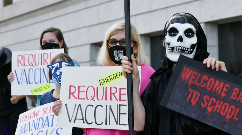 A group of protesters from the United Campus Workers of Georgia, Local 3265, rallies on Tuesday, August 10, 2021, outside the building in downtown Atlanta where the Board of Regents meets urging the University System of Georgia to institute a policy requiring everyone wear masks or be vaccinated to be on campus. (Hyosub Shin / Hyosub.Shin@ajc.com)
