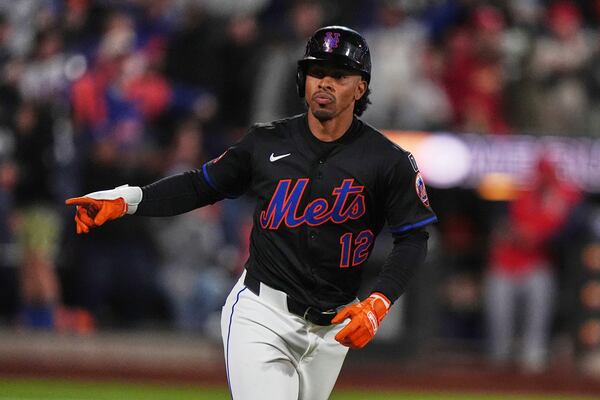 New York Mets' Francisco Lindor (12) gestures to teammates as he runs the bases after hitting a walk-off home run during the ninth inning of a baseball game against the St. Louis Cardinals Friday, April 18, 2025, in New York. (AP Photo/Frank Franklin II)
