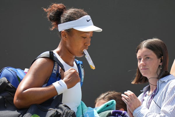 Naomi Osaka of Japan leaves the court after losing to Russia's Anastasia Pavlyuchenkova during a third round women's singles match at the Wimbledon Tennis Championships in London, Friday, July 4, 2025. (AP Photo/Alastair Grant)