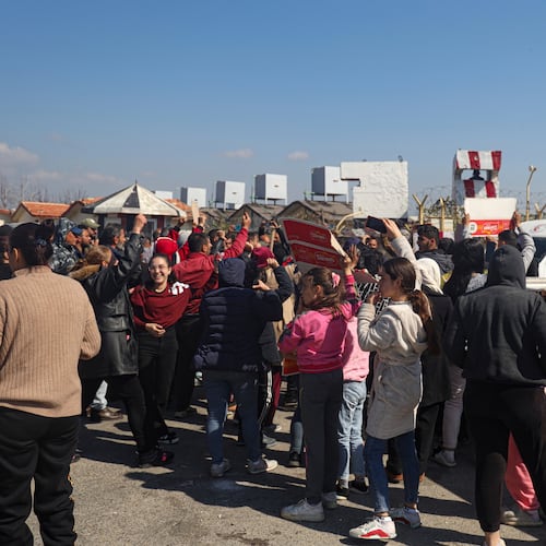 FILE - Members of the Alawite minority gather outside the Russian air base in Hmeimim, near Latakia in Syria's coastal region, March 11, 2025, as they seek refuge there after recent violence and retaliatory killings in the area. (AP Photo/Omar Albam, File)