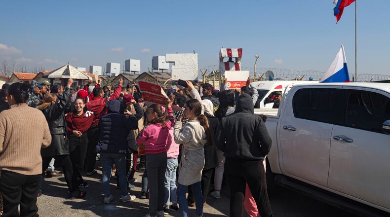 FILE - Members of the Alawite minority gather outside the Russian air base in Hmeimim, near Latakia in Syria's coastal region, March 11, 2025, as they seek refuge there after recent violence and retaliatory killings in the area. (AP Photo/Omar Albam, File)