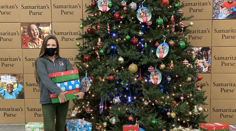 Marika Chasse of Johns Creek helps out at the Southeast distribution site for Samaritan's Purse Operation Christmas Child. More than 2.1 million shoeboxes filled with gifts will be sent to children throughout the world from this location. (Courtesy of Samaritan's Purse Operation Christmas Child)