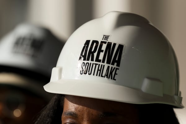A media member wears a branded construction hat during a tour of the 268,000-square-foot The Arena at Southlake complex. (Jason Getz/AJC)