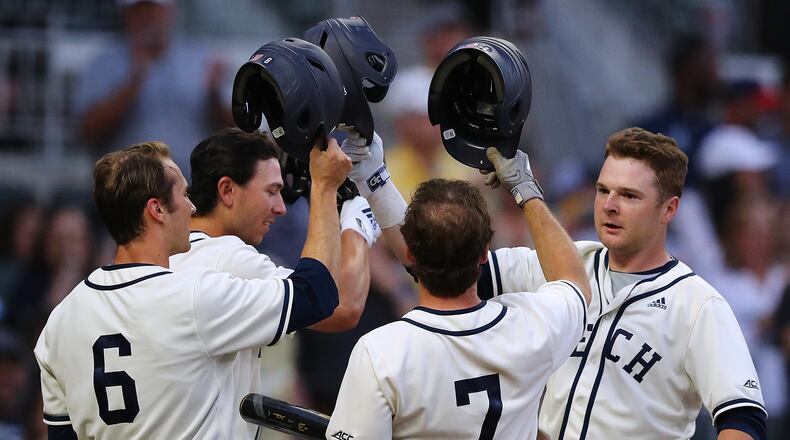 April 23, 2019 Atlanta: Georgia Tech players Michael Guldberg (from left), Tristin English, and Luke Waddell greet catcher Kyle McCann at home as he hits a 3-RBI home run to take a 6-2 lead over Georgia during the second inning in the Spring Classic NCAA college baseball game at SunTrust Park on Tuesday, April 23, 2019, in Atlanta.    Curtis Compton/ccompton@ajc.com