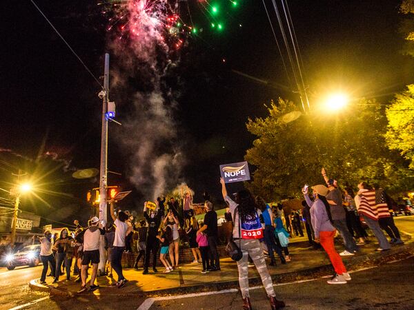East Atlanta celebrates with honking and signs and amateur fireworks as election results become more clear and celebrations for President-Elect Joe Biden and VP Kamala Harris begin on Saturday, Nov 7, 2020.   (Jenni Girtman for The Atlanta Journal-Constitution)