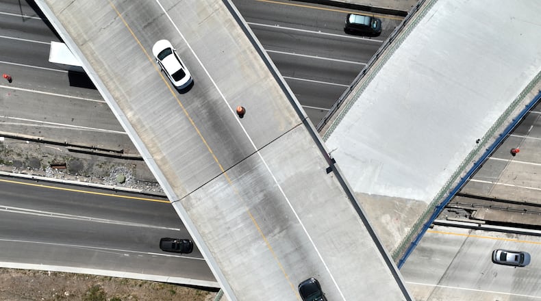 This aerial photo shows construction of the I-285 interchange at Ga. 400 in Sandy Springs in May. The state plans to open new westbound I-285 exit lanes to Ga. 400 on Monday. (Hyosub Shin / Hyosub.Shin@ajc.com)