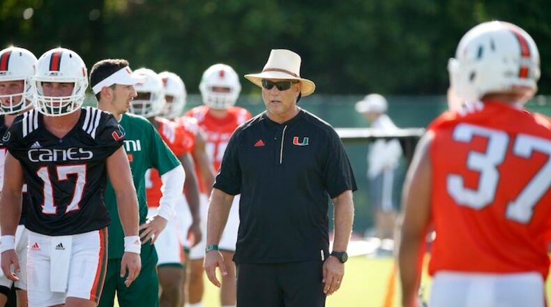 Miami head coach Mark Richt, center, looks on during practice on the first day of NCAA college football fall camp, Tuesday, Aug. 1, 2017 in Coral Gables, Fla. (AP Photo/Wilfredo Lee)