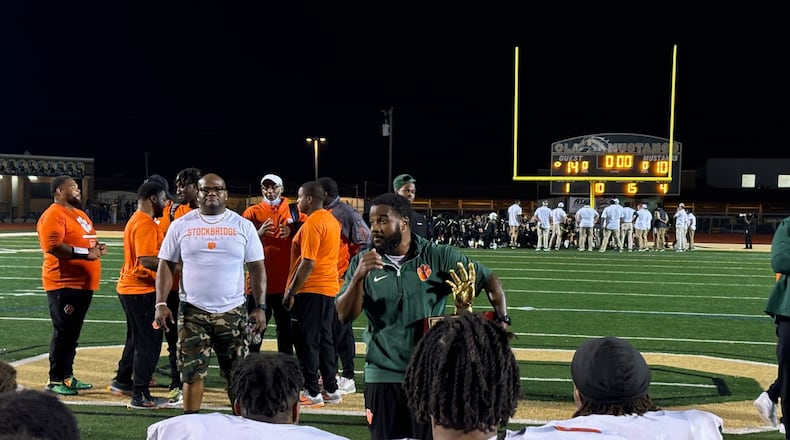 Stockbridge coach Kendrick Callier (center) talks to his players after their 14-10 win over Ola, Oct. 4, 2024