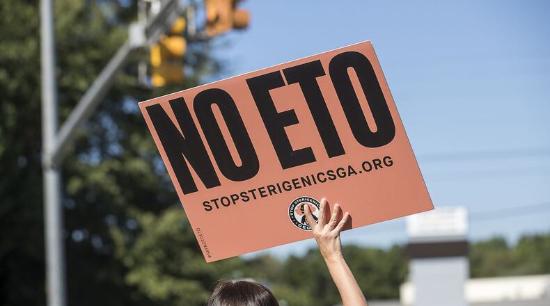 A Stop Sterigenics Georgia protestor holds a sign during a protest in near Smyrna. (Alyssa Pointer/alyssa.pointer@ajc.com)
