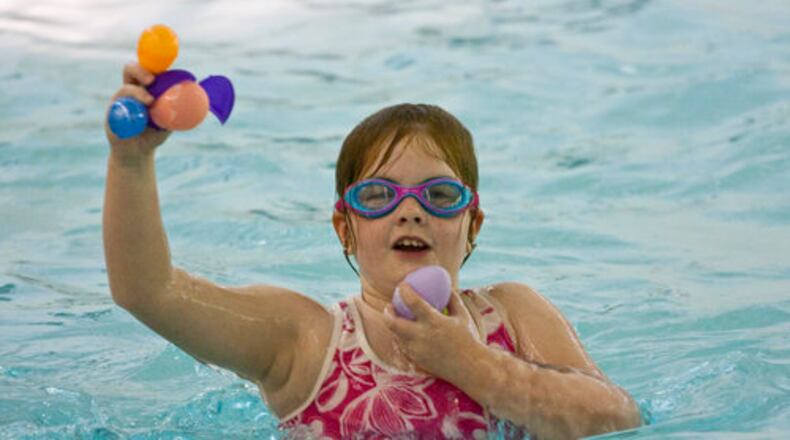 Hannah Harden, of Grayson, does her Easter egg hunting in her swimsuits at the Underwater Easter Egg Hunt at Bethesda Park Aquatic Center in Lawrenceville.