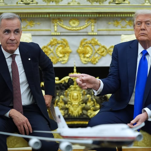 FILE - President Donald Trump gestures alongside Canadian Prime Minister Mark Carney as they meet in the Oval Office of the White House, Oct. 7, 2025, in Washington. (AP Photo/Evan Vucci, File)