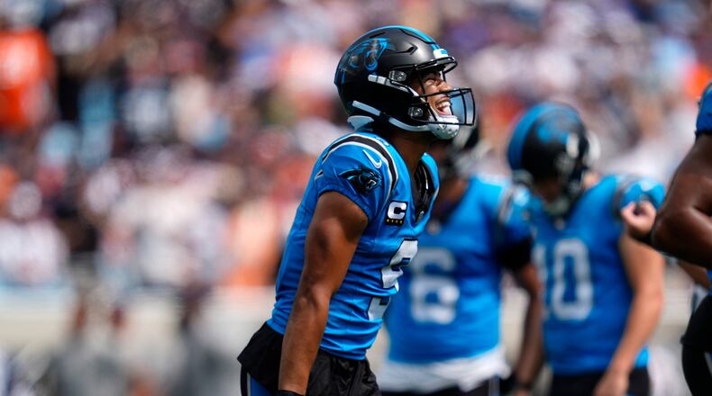Carolina Panthers quarterback Bryce Young (9) celebrates after scoring a touchdown during the first half of an NFL football game, Sunday, Sept. 13, 2026, in Charlotte, N.C. (AP Photo/Erik Verduzco)