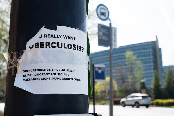 A sign about tuberculosis taped to a light pole across the street from the Centers for Disease Control and Prevention headquarters in Atlanta on Tuesday, April 1, 2025. (AP Photo/Ben Gray)