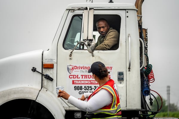 An instructor provides reverse parking advice to a student at the Driving Academy on Tuesday, June 10, 2025 in Linden, N.J., where students prepare to obtain a Commercial Driver’s License (CDL) with multilingual instructors.(AP Photo/Angelina Katsanis)