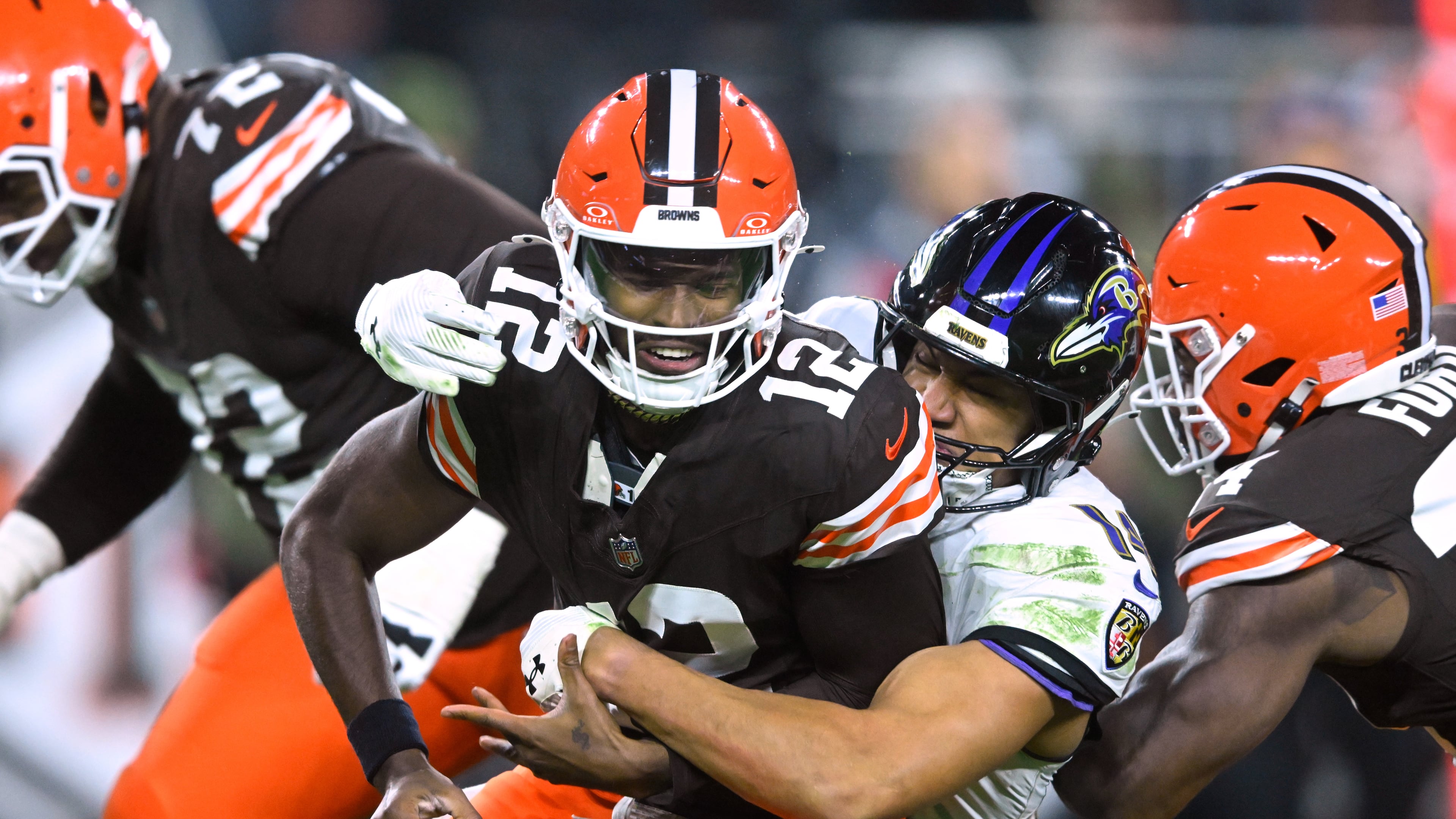 Cleveland Browns quarterback Shedeur Sanders (12) is sacked by Baltimore Ravens safety Kyle Hamilton (14) in the second half of an NFL football game in Cleveland, Sunday, Nov. 16, 2025. (AP Photo/David Richard)